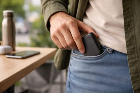 Kleine kompakte Powerbank wird in eine Hosentasche gesteckt